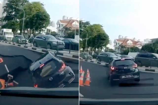 شاهد.. حفرة ضخمة تبتلع سيارة في أحد شوارع سنغافورة