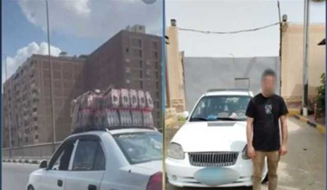 ضبط سائق سمح لشخص بالجلوس على الجزء الأمامي من سيارته